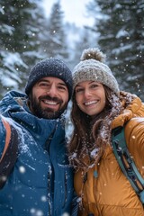 A couple is smiling and posing for a picture in the snow