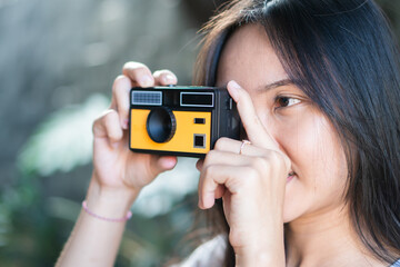 Young Woman Taking Photo with Vintage Camera