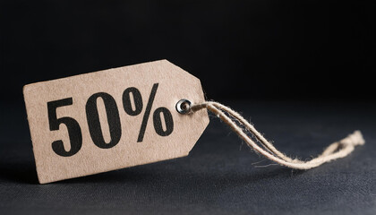 Sale tag with text 50% off on black background. For promoting discounts and shopping events.