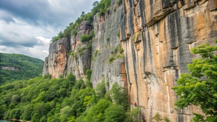 Naklejka premium Majestic cliffs rise above lush green forests.