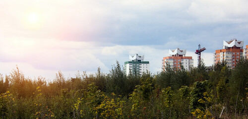 Urban Development Overlooking Lush Greenery in A Serene Landscape During a Cloudy Evening at Dusk