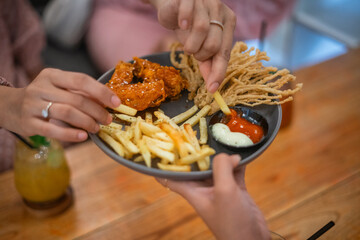 A delicious plate of crispy fries, tender chicken, and dips, perfect for sharing
