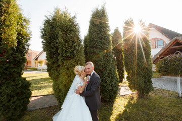 A woman's feet are shown in front of a pair of white shoes. The shoes are high heels and the woman is wearing a white dress. Concept of elegance and sophistication