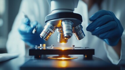 Close-up of a scientist hand adjusting microscope settings, with a clear view of the lab surroundings