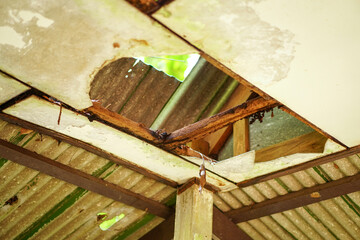 The damaged wooden roof structure of the pavilion. Home renovation or repair concept.