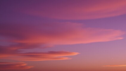 Fototapeta premium Stunning panorama of sunset cloudscape showcasing a blend of vibrant purples pinks and oranges with soft wispy clouds against the peaceful tranquility of an evening sky