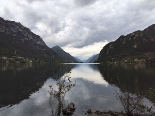 Italy (Italia) - Landscape with lake between mountains and the alpine in the distance