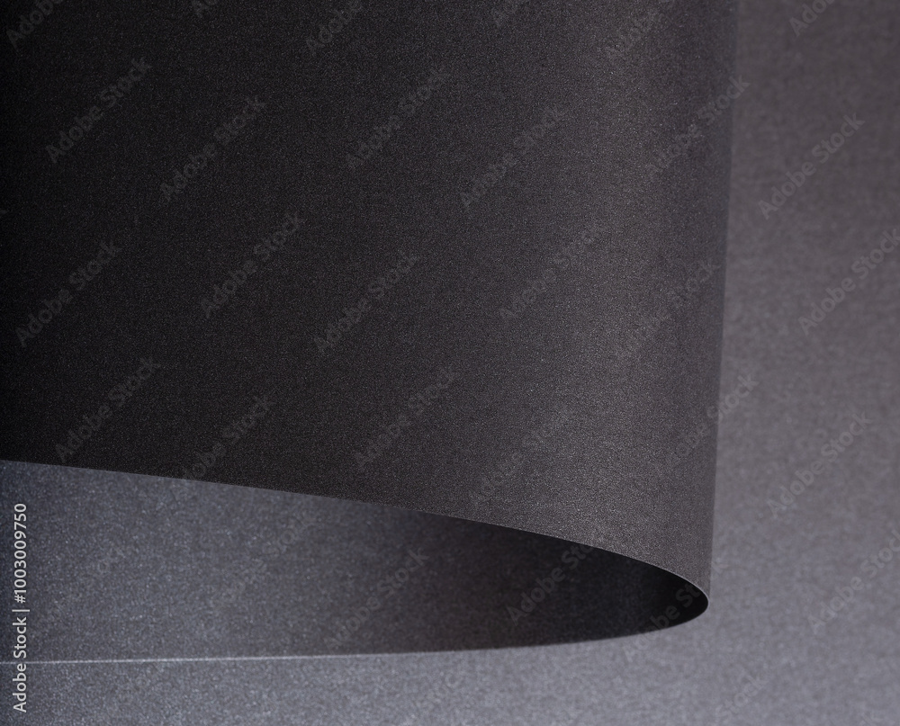 Poster Black paper with a rich texture and minimalist monochrome background. The design features bent and twisted folds, creating stylish shadows and light effects. Curved layers add a
