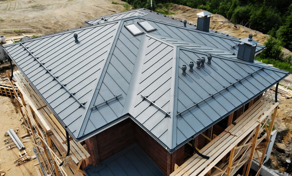 Aerial view of house retro roof panel with standing seam, fastener. Modern galvanized steel roofing sheet with ribs. Classic style gray metal panel with rebate joint. Falz roofing. Building's covering