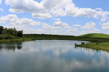 Fototapeta premium The calm pond in the countryside on a sunny day.