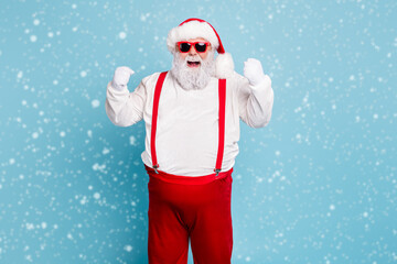 Portrait of funny funky fat santa claus with big belly raise fists scream yeah have luck celebrate...