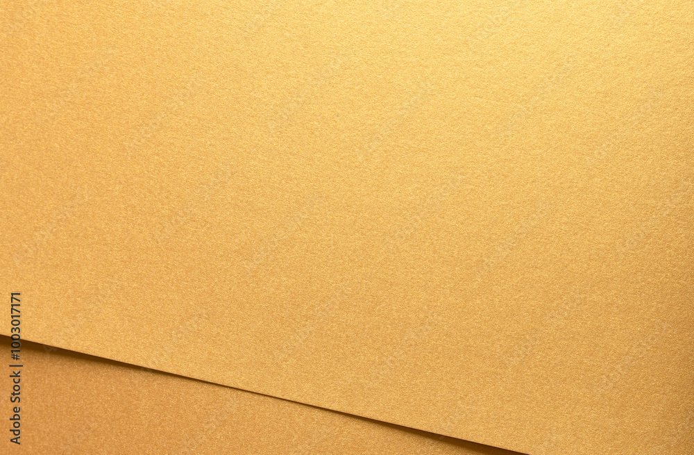 Aufkleber Golden metallic paper with a glossy texture and layered folds. The rich, warm surface shines with glowing gradients, creating an elegant and luxurious backdrop. This minimalist