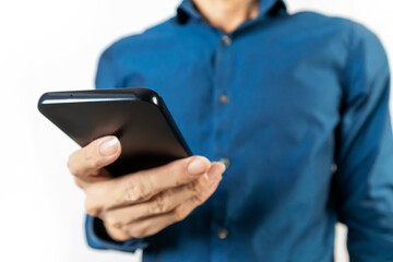 Businessman using mobile phone to view messages and work details on mobile phone