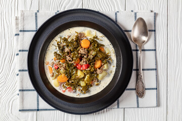 ground beef veggies kale soup in black bowl