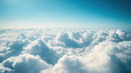serene aerial view of fluffy white clouds from airplane window conveying sense of wonder and tranquility above the world