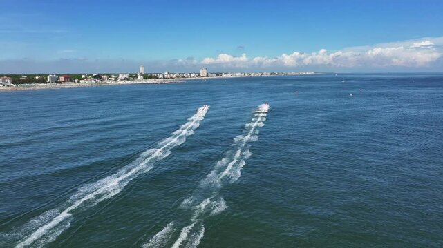Aerial view of some offshore speedboats sailing on the blue waters of the Adriatic Sea. Cervia, Ravenna, Italy