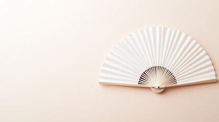 Elegant White Folding Fan with White Paper on Solid Color Background
