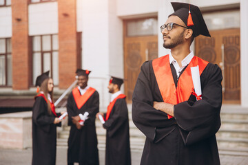 Confident Indian Male Graduate Standing Proud With Diploma at University Ceremony