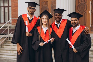 Group Of Happy Graduates Celebrating Success In Academic Graduation Ceremony Outdoors