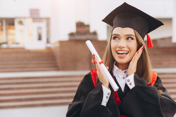Smiling Female Graduate Celebrating Achievement in Cap and Gown at University Ceremony