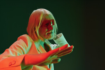 elderly man with long white hair, artistic pose, vibrant colors, green and red lighting, modern art...