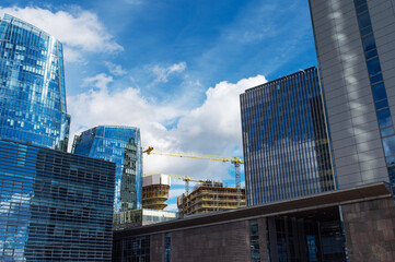 Naklejka premium Lithuania Economy. Booming concept. Business and Real Estate. Beautiful view of Vilnius business district with cranes building new building illustration. City life in Vilnius, Lithuania.