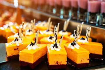 Orange carrot cakes on a plate.