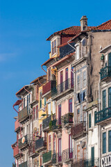 Close up of the famous riverside buildings in Porto. Colorful facades with colored steel balconies. on a sunny day