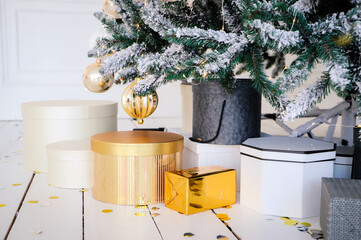 Close-up of Christmas presents in wrapping paper are on the floor under the Christmas tree