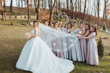 A woman is getting ready for a wedding, and she is standing in front of a dresser with a wedding...