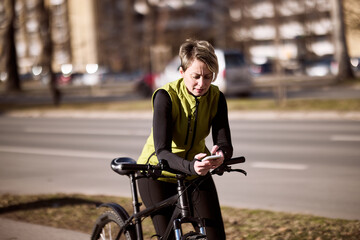 Woman Leaning to Bike Texting on Cell Phone