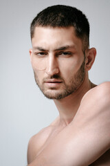 Obraz premium Man facial care skin rejuvenation face eye patches. Man facial care. Skin rejuvenation. Cosmetic product advertising. Satisfied caucasian guy applying collagen gel face eye patches on grey background.