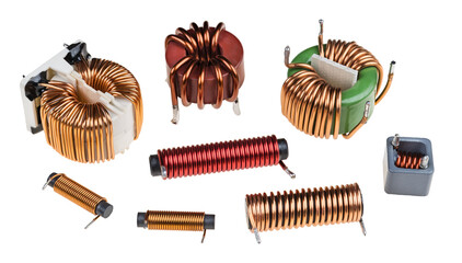 Set of toroid or cylindric coils with copper wire isolated on white background. Closeup of inductors or transformers with ferrite core. Various electronic components to store energy in magnetic field.