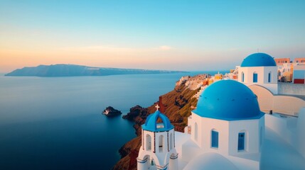 Fototapeta premium Aerial shot of Santorini's white houses with blue domes perched on cliffs overlooking the Aegean Sea 
