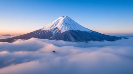 Wintery aerial of Mount Fuji with the Chureito Pagoda, both blanketed in snow, soft winter light on the horizon 