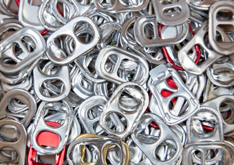 Close up of metal ring pulls from aluminum can caps for recycle. Aluminum pull ring