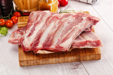 Raw pork ribs over board