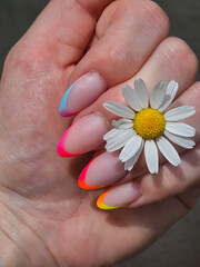 Girl with chamomile color manicure close-up. High quality photo