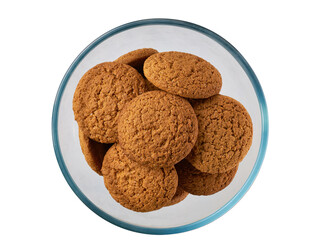 oatmeal cookies in a clear glass bowl isolated on white background, top view.