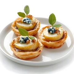 Elegant pear and blue cheese tarts with walnuts and honey garnish on plate