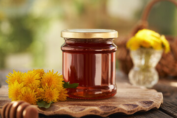 A jar of dandelion honey - syrup made of fresh Taraxacum flowers in spring