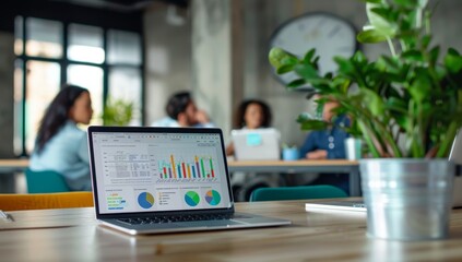 Laptop on the table in an office, displaying Analysts in the workplace are studying financial data for marketing strategy at the workspace, dashboard paper format with graphs and charts
