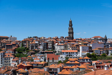 Clerigos Tower, Clerigos Church in downtown Porto, Portugal. House of the Brotherhood. Old town of Porto, view with colorful houses. Blue sky, sunny day.