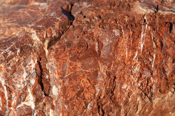 Red stone with white stripes. Stone background.