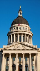 Fototapeta premium Majestic Michigan State Capitol glimmers against a blue sky with sunlit dome and pillars