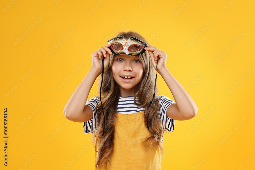 Poster Cute girl wearing carnival mask on orange background