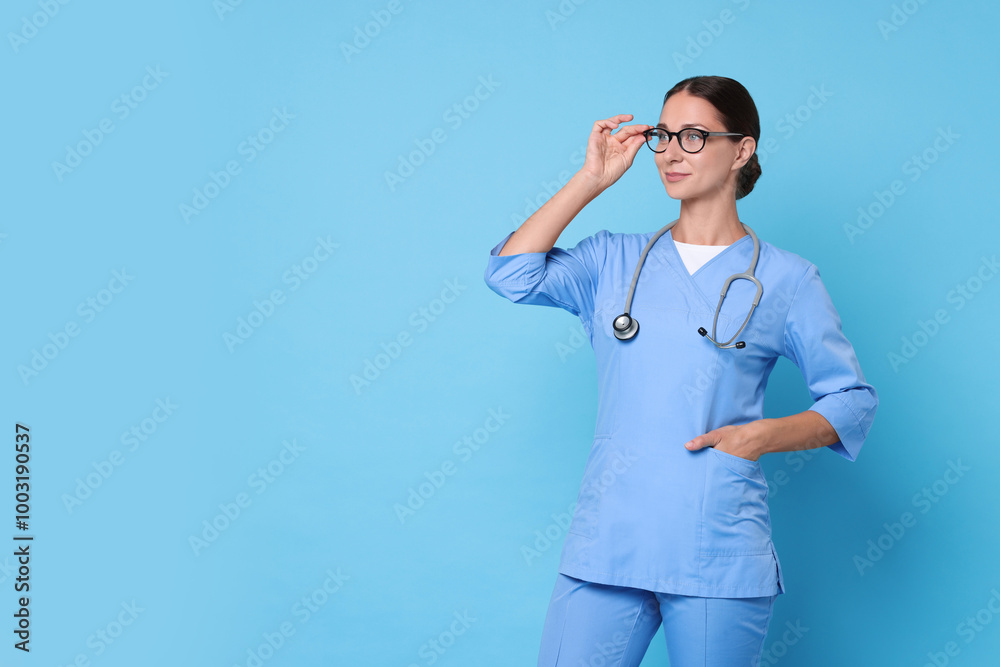 Sticker Nurse in medical uniform with stethoscope on light blue background, space for text