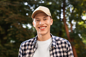 Portrait of smiling man in baseball cap outdoors