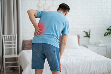 Back pain, kidney stones, inflammation and disease, man suffering from backache at home