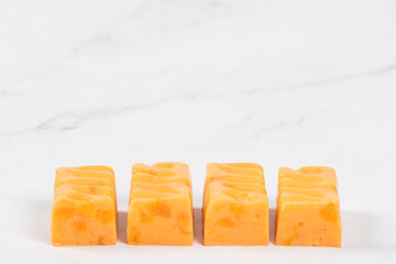 Modern Vegan dessert. Apricot nougat with pieces of dried apricots. White background. Copy space